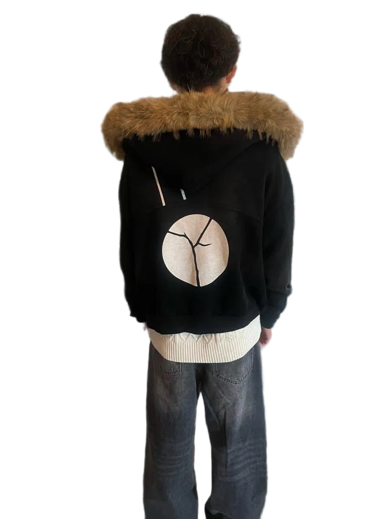 Black boxy hoodie with detachable brown fur trim and a large white circular graphic on the back.