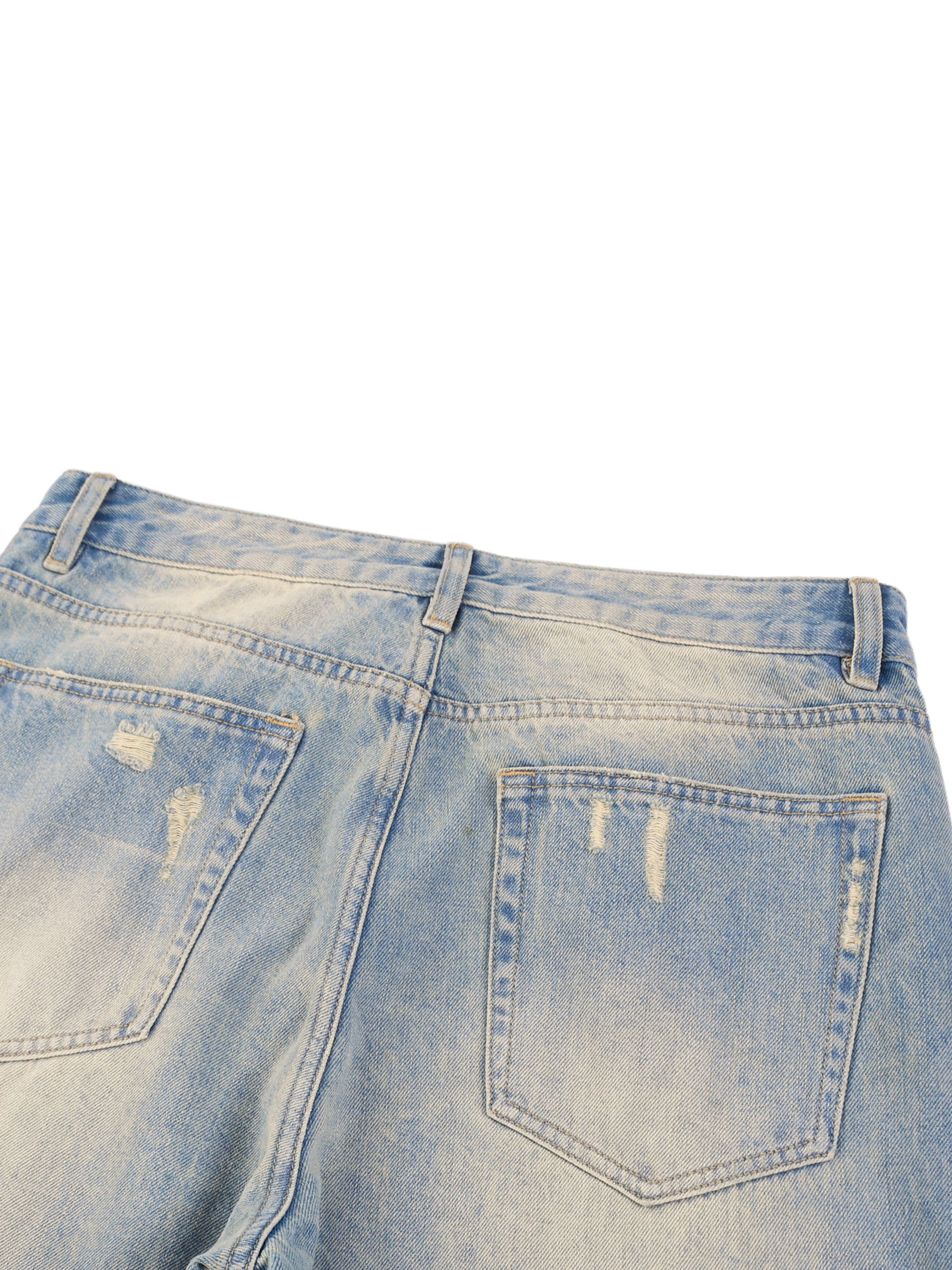Back view of sun fade raw hem denim jeans with distressed pockets and mid-waist.
