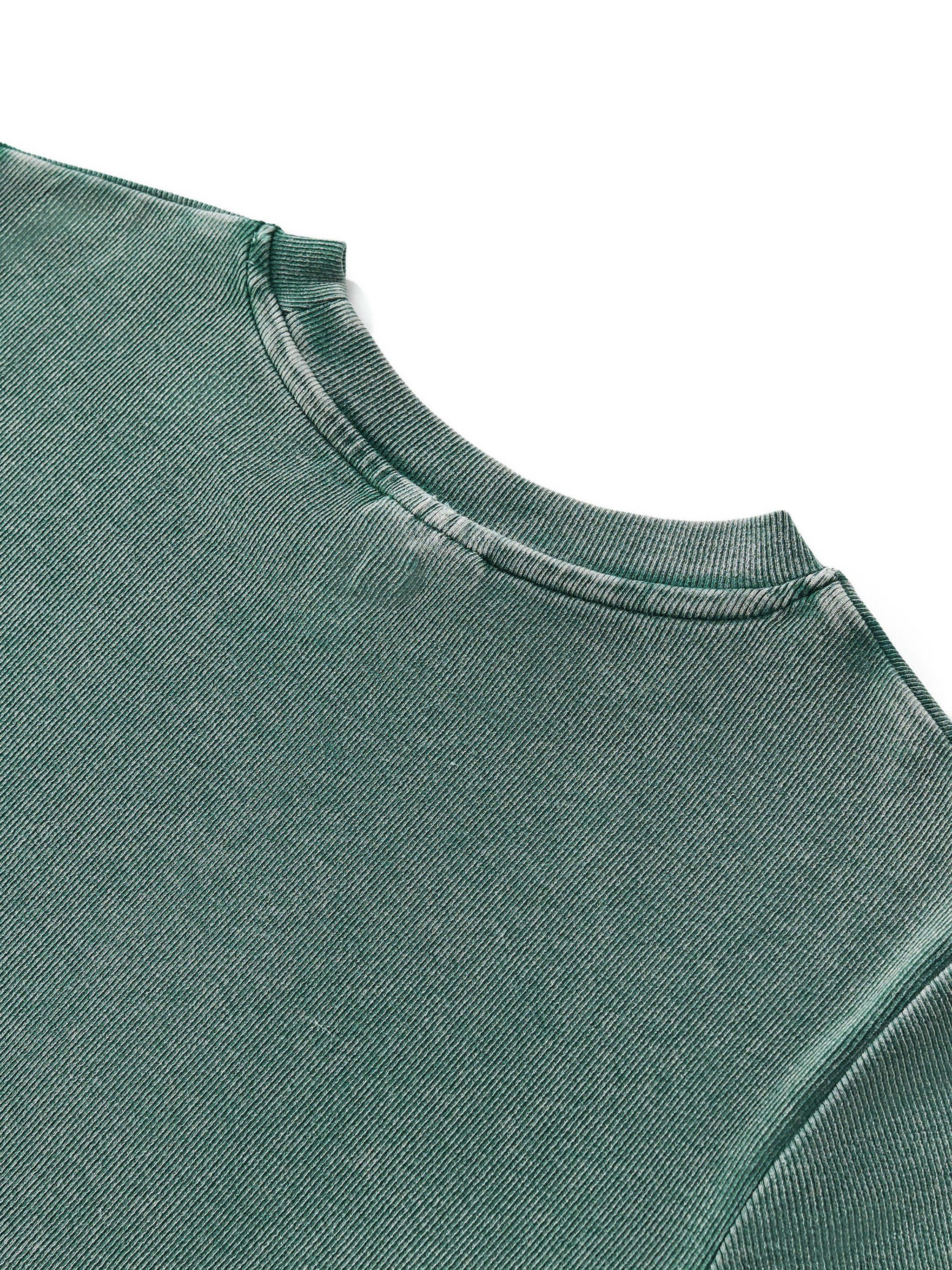 Close-up of a vintage washed dark green cotton blend bodycon t-shirt with a round neck.