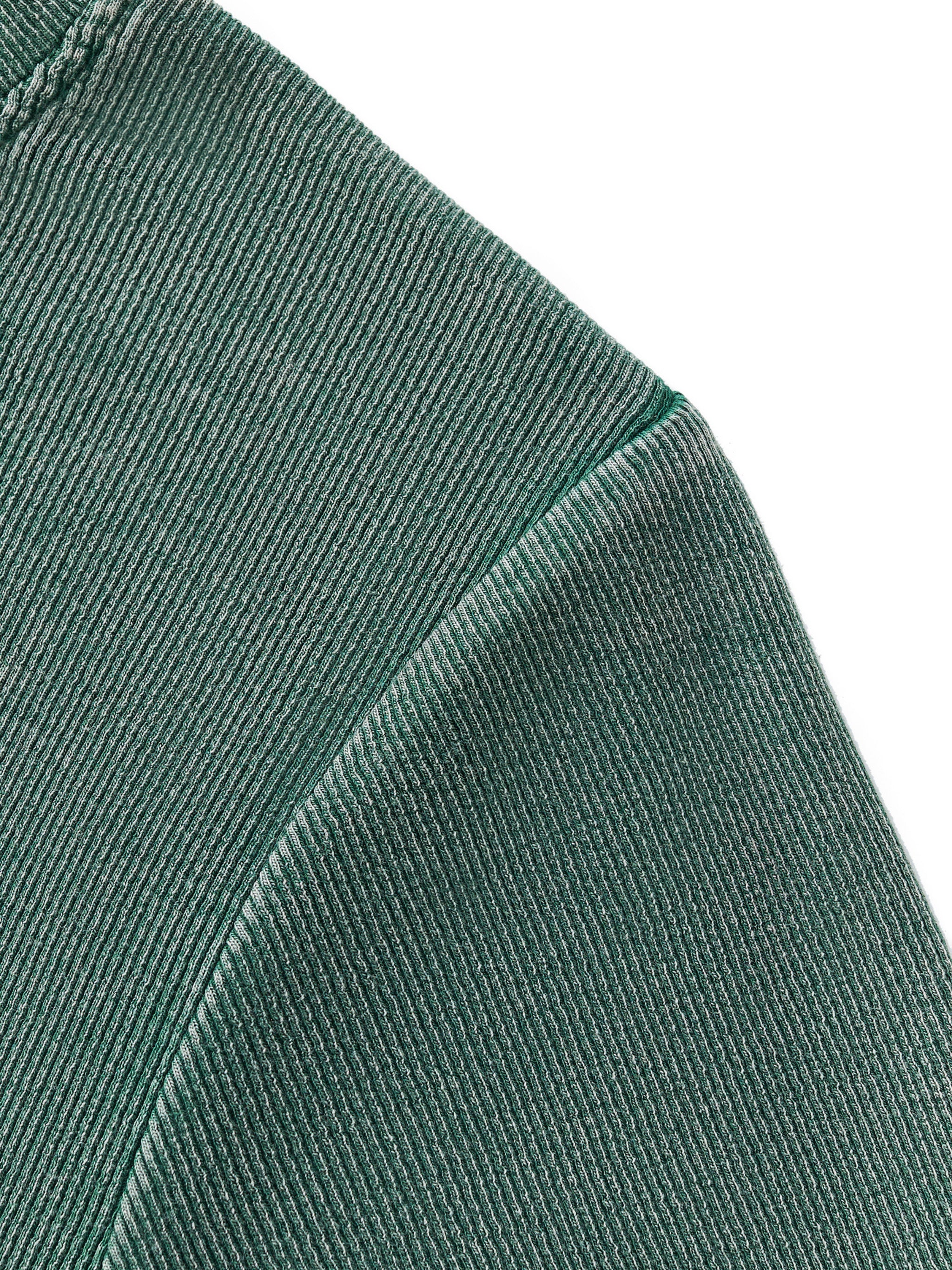 Close-up of a vintage washed dark green ribbed cotton blend bodycon t-shirt shoulder seam.