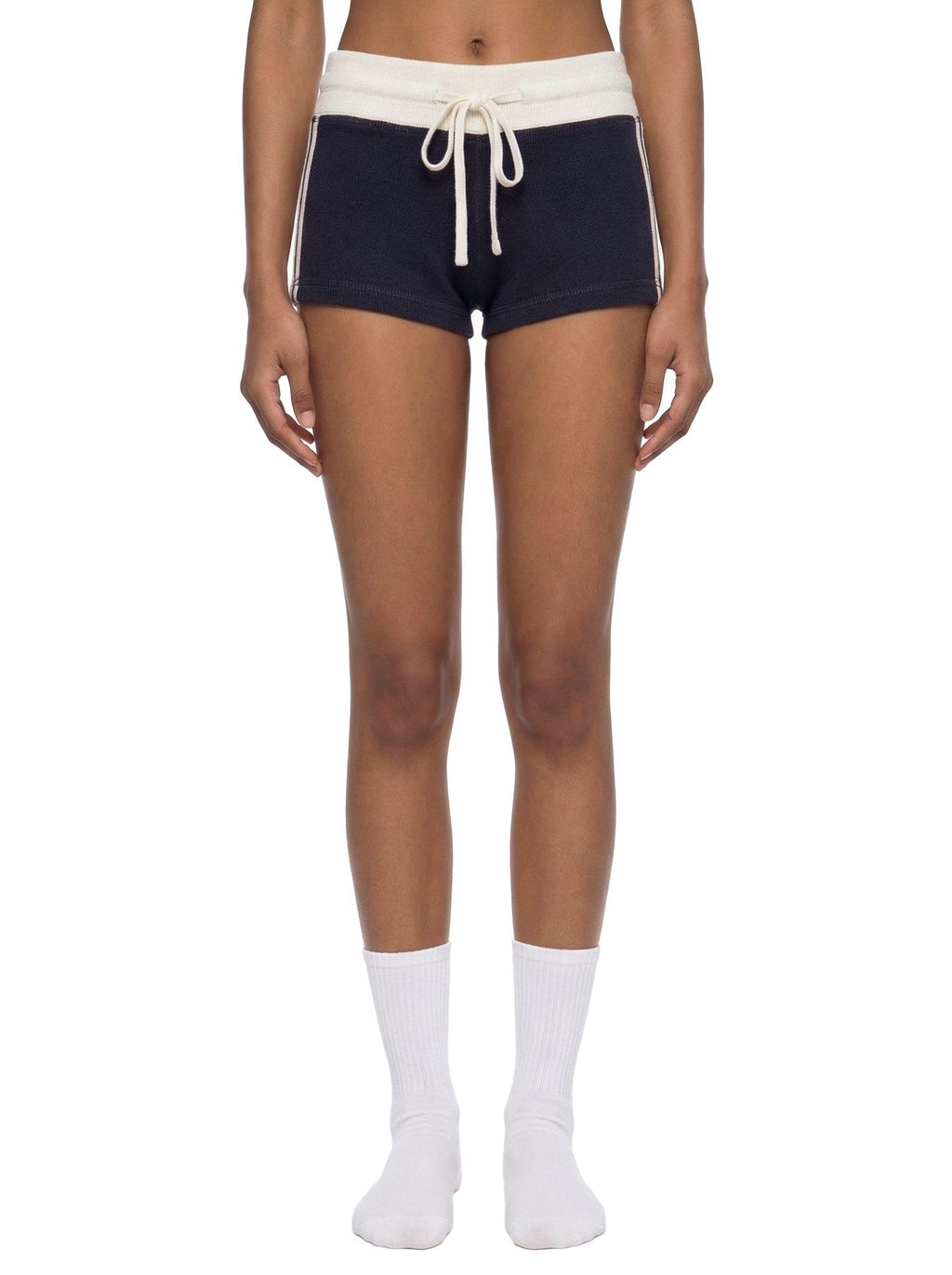 Women's navy contrast stripe track shorts with a white drawstring waist, shown on a model.