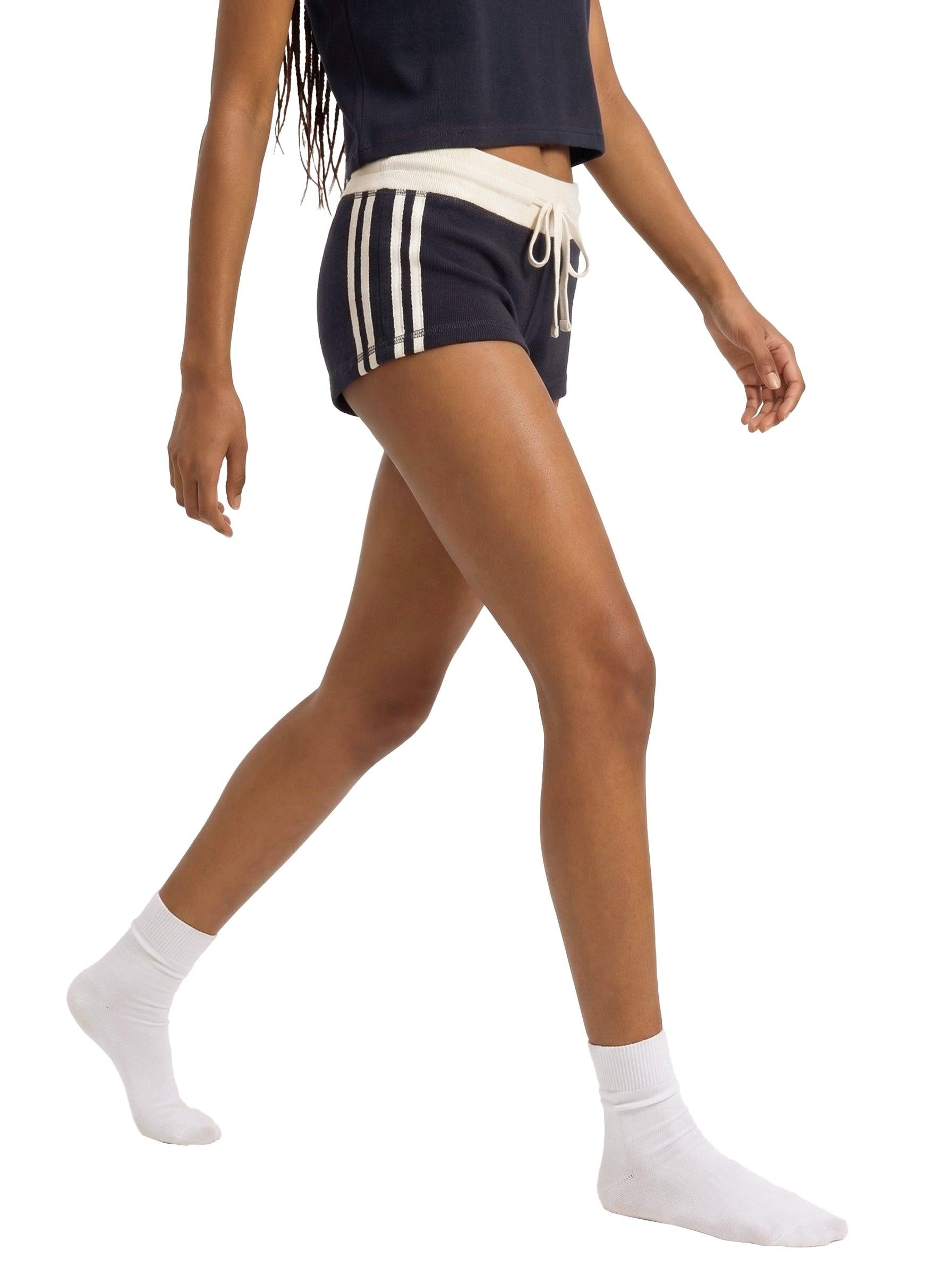 Women's navy contrast stripe track shorts with a cream waistband and drawstring, made from cotton, modal, and polyester.