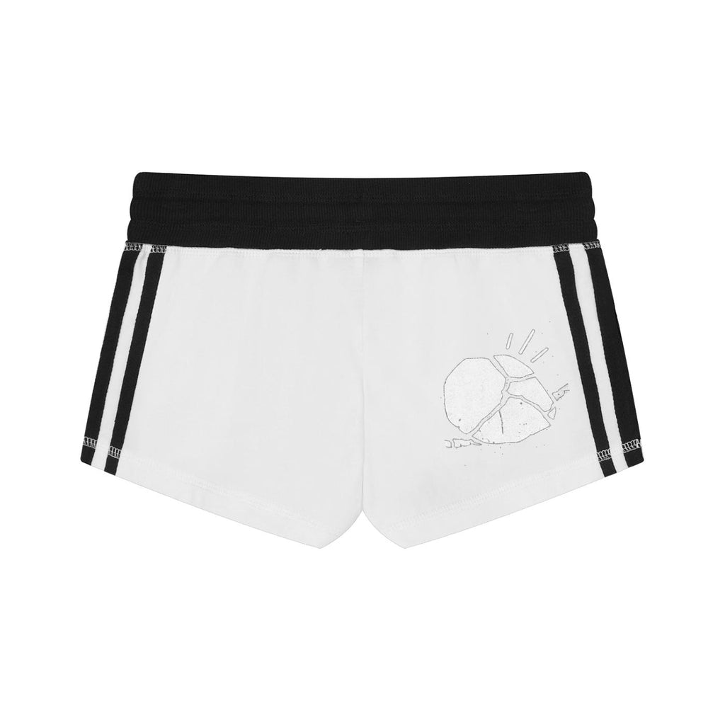 Women's white track shorts with black elastic waistband, black side stripes, and a subtle graphic print.